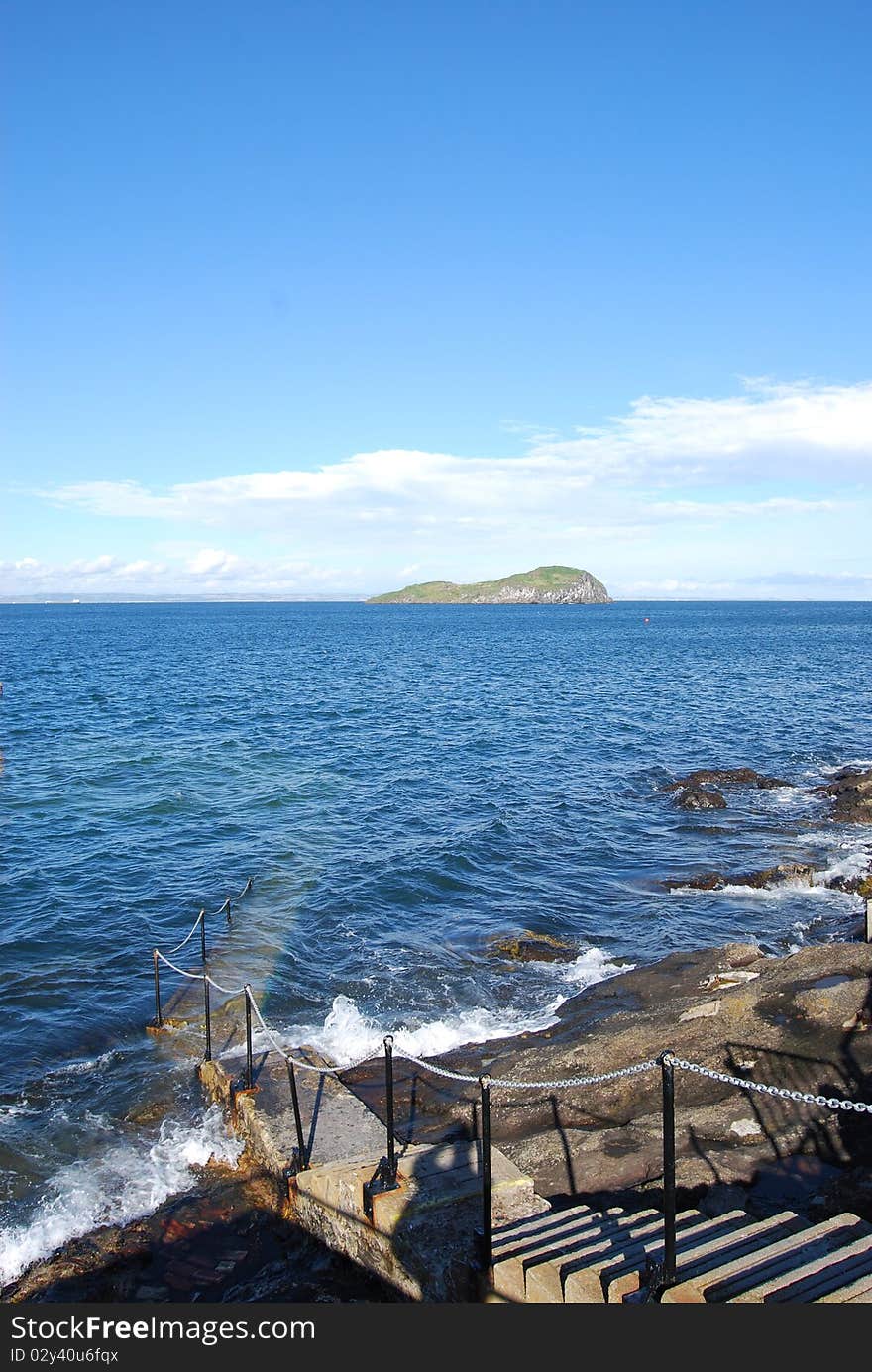 Stone steps descend into the stormy waters of the firth of Forth at North Berwick. Stone steps descend into the stormy waters of the firth of Forth at North Berwick