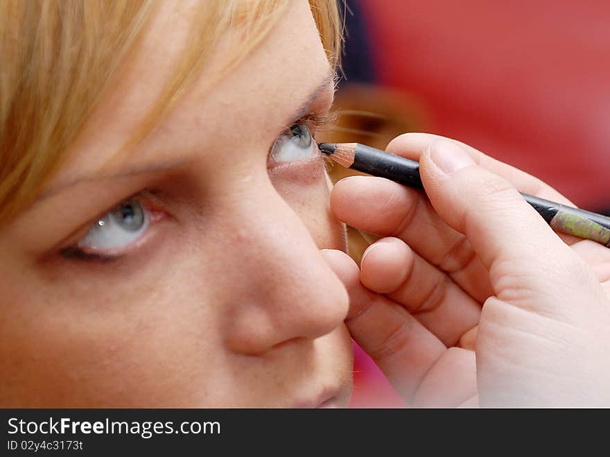 Portrait of beauty young caucasian woman applying eyeshadow