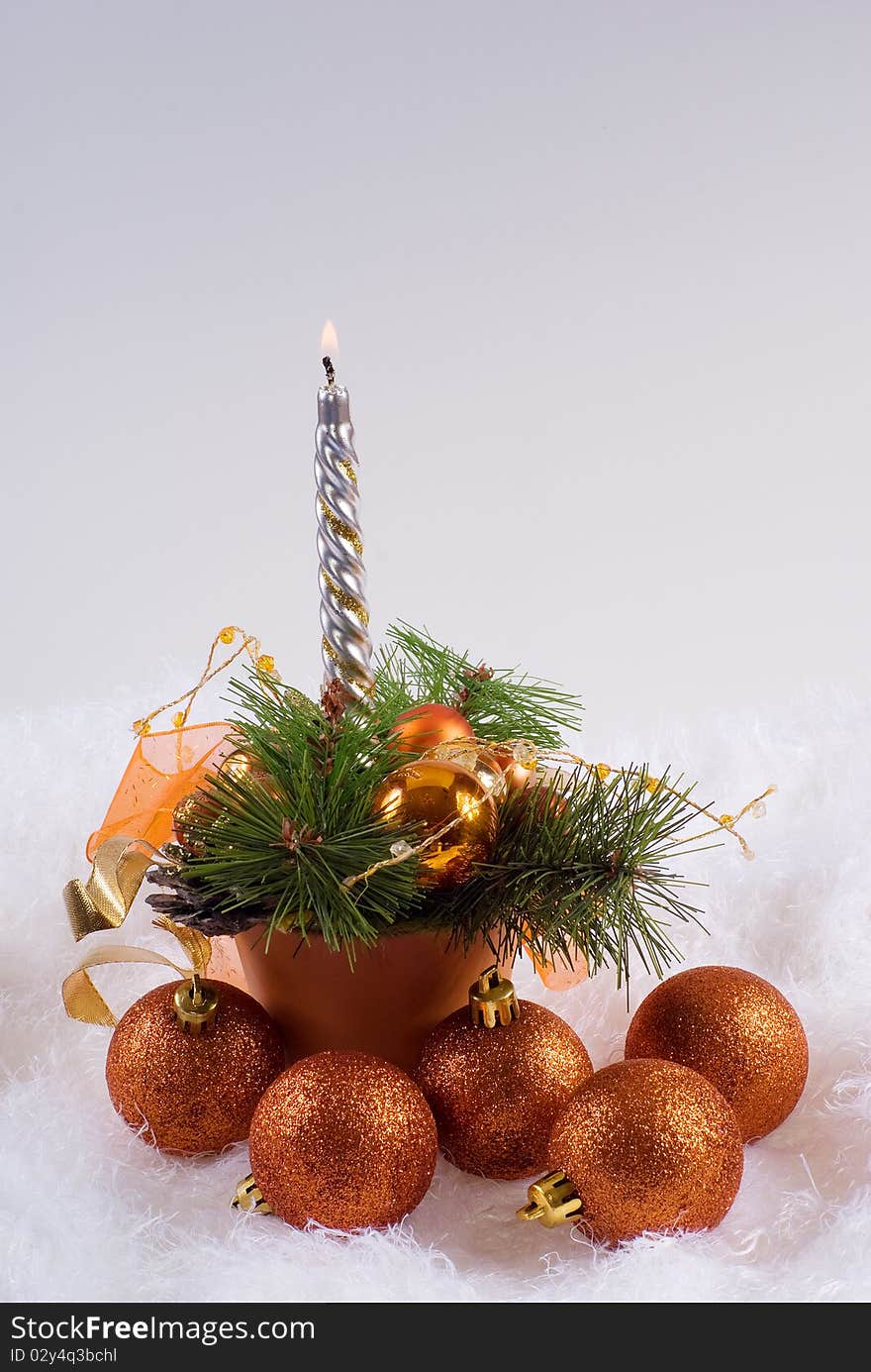 Christmas orange spheres and the silver candles on the white fur