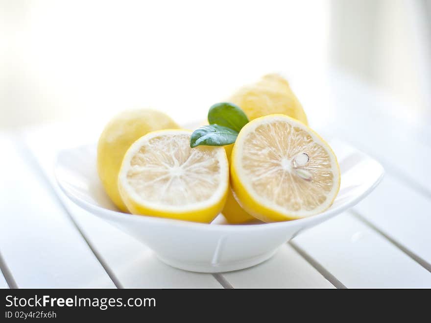 Beautiful fresh cut lemons on garden table. Beautiful fresh cut lemons on garden table