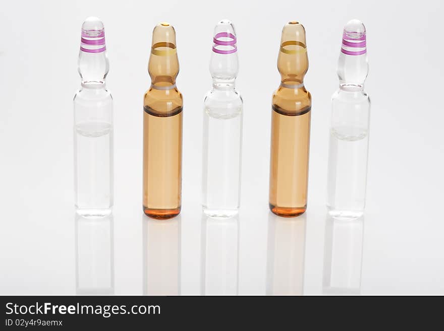 Medical ampules or vials in a row isolated on a white background