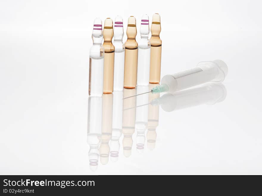 Medical Vials With Syringe Isolated On White