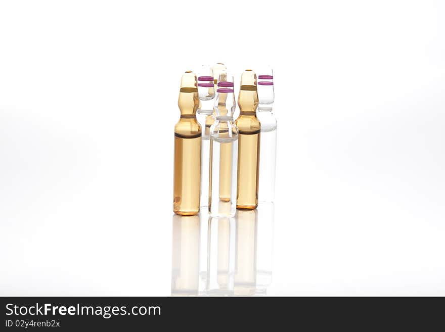 Medical ampules or vials in a row isolated on a white background. Medical ampules or vials in a row isolated on a white background