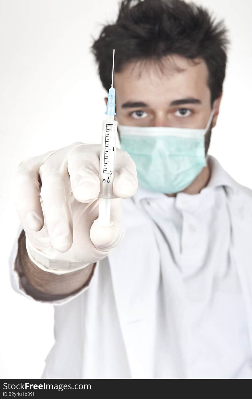 Male doctor holding a syringe. focus on syringe and isolated on white