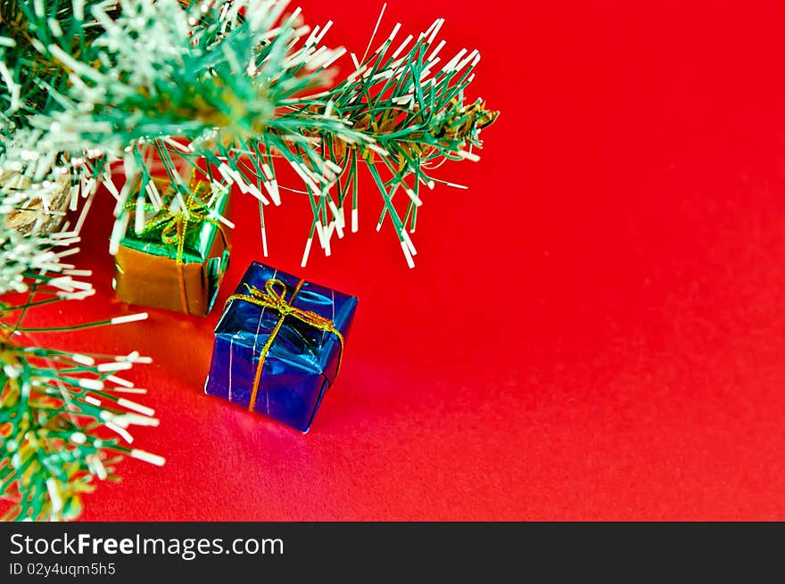 Christmas tree is richly decorated with a red background