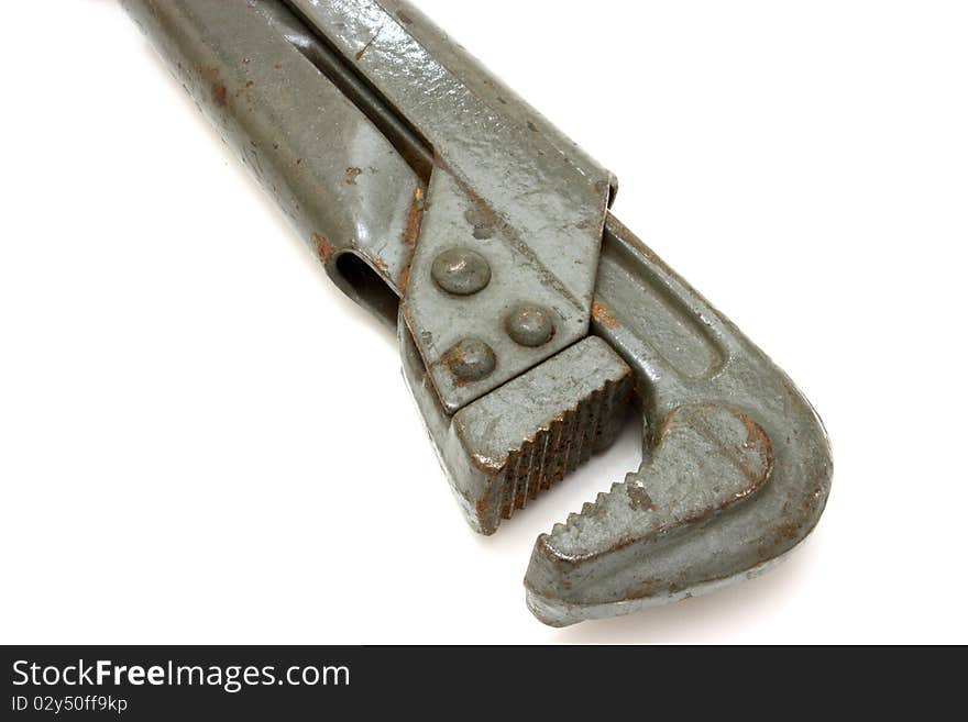 The big metal wrench for untwisting of pipes on a white background