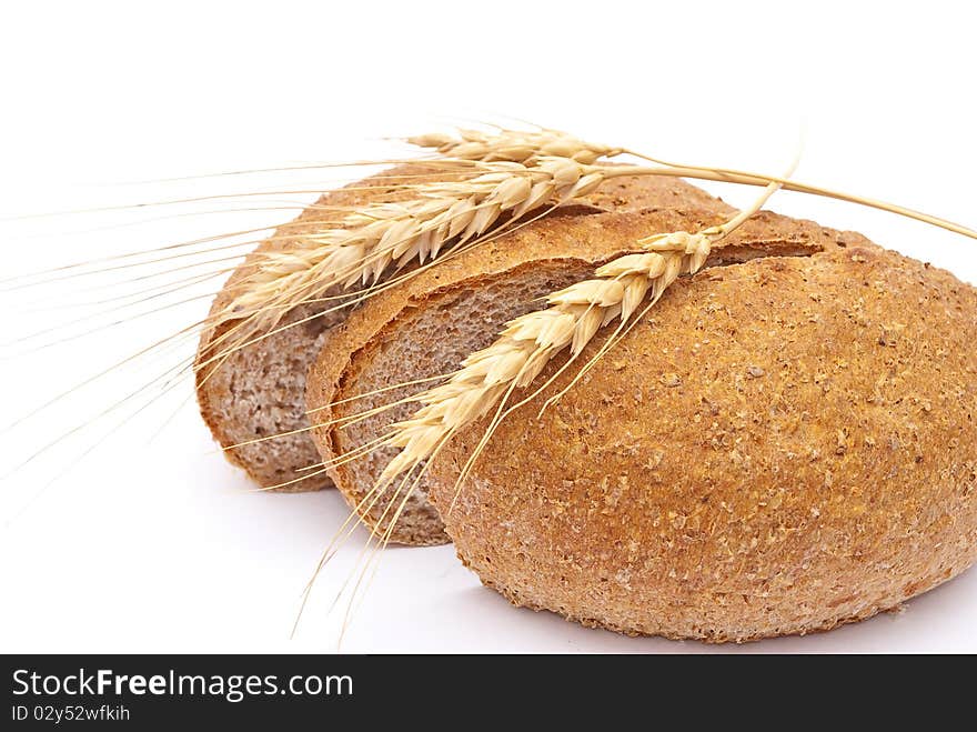 Bread with wheat and ears on white