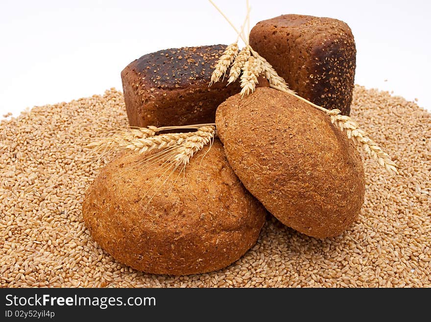 Bread with wheat and ears on white