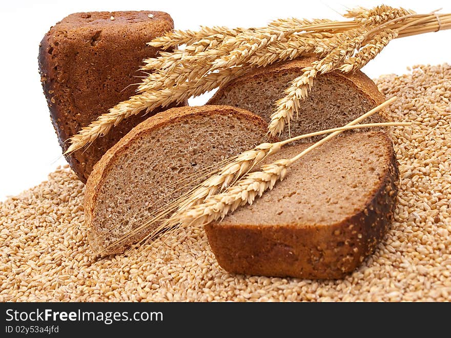 Bread with wheat and ears on white