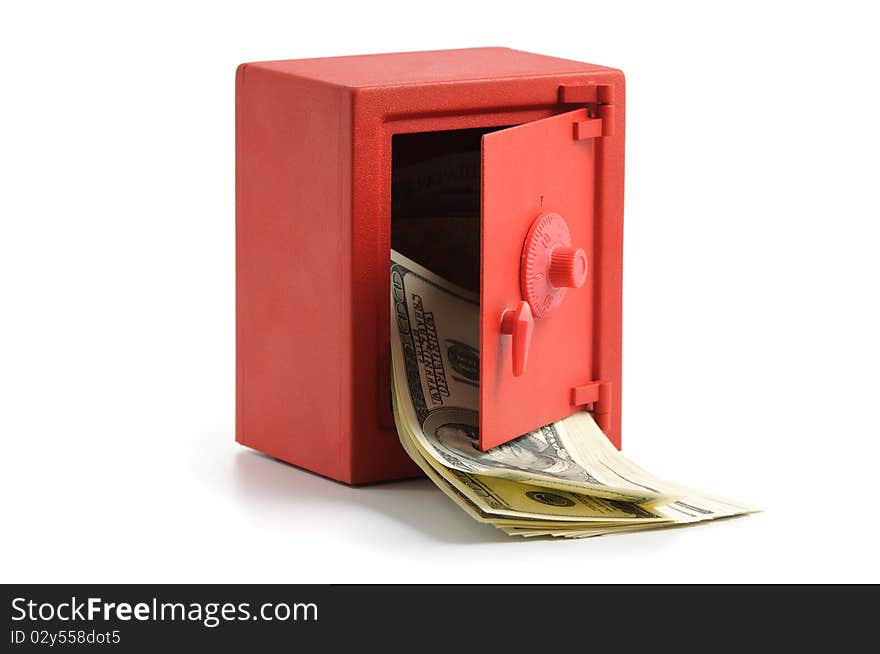 Little red safe with the door open and a stack of dollar bills. Little red safe with the door open and a stack of dollar bills