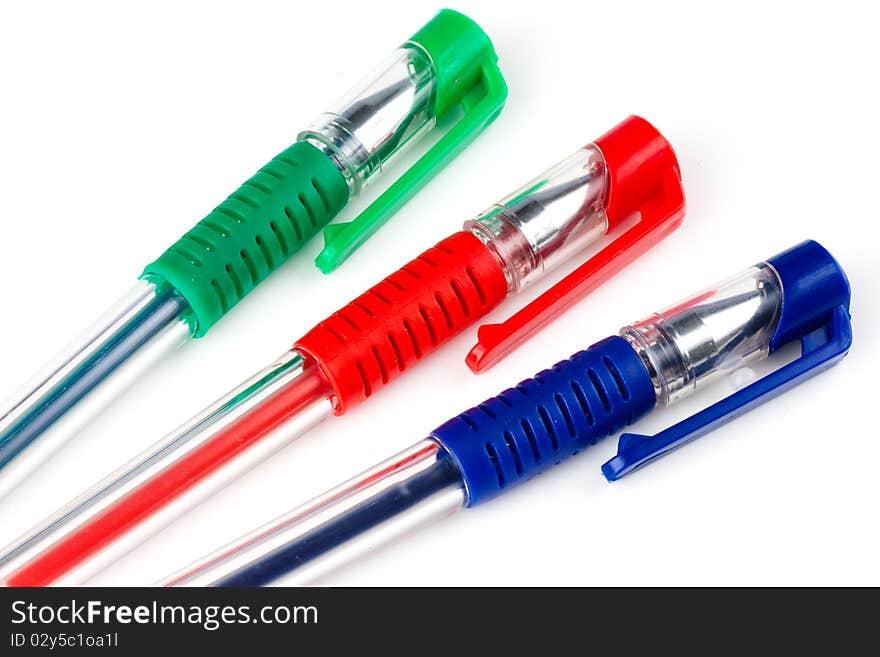 Three pens consisting of blue red and green on white background