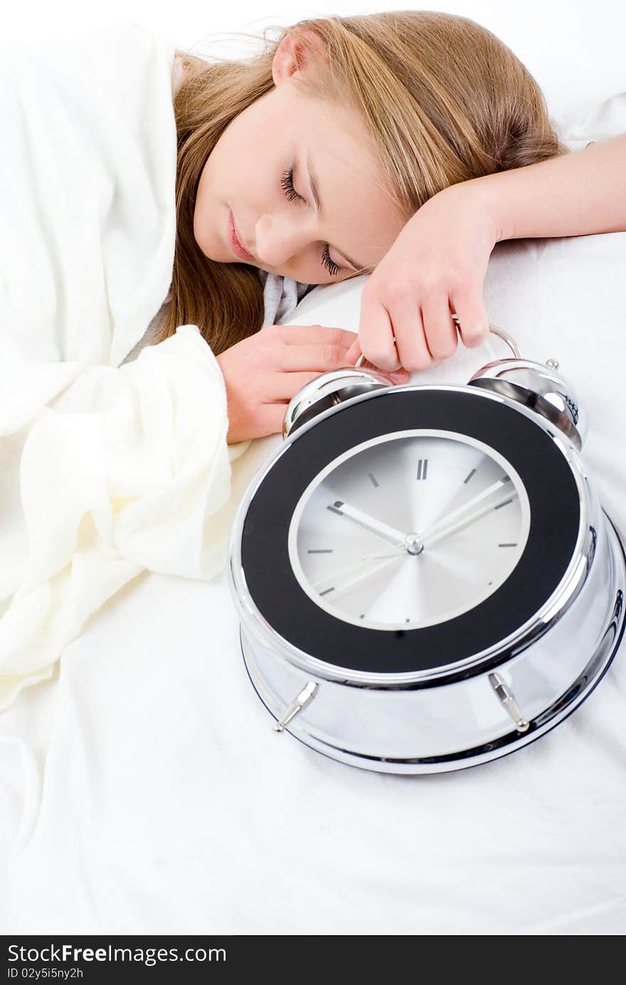 Sleeping girl with an alarm-clock in his hand. Sleeping girl with an alarm-clock in his hand.