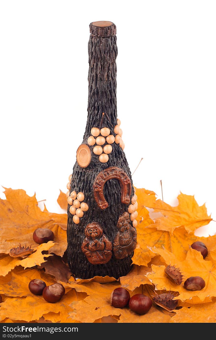 Wooden bottle on the yellow leaves of an isolated