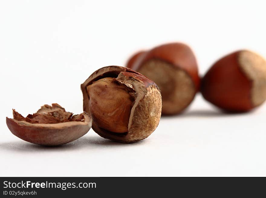 Cracked forest nut with shell isolated on the white