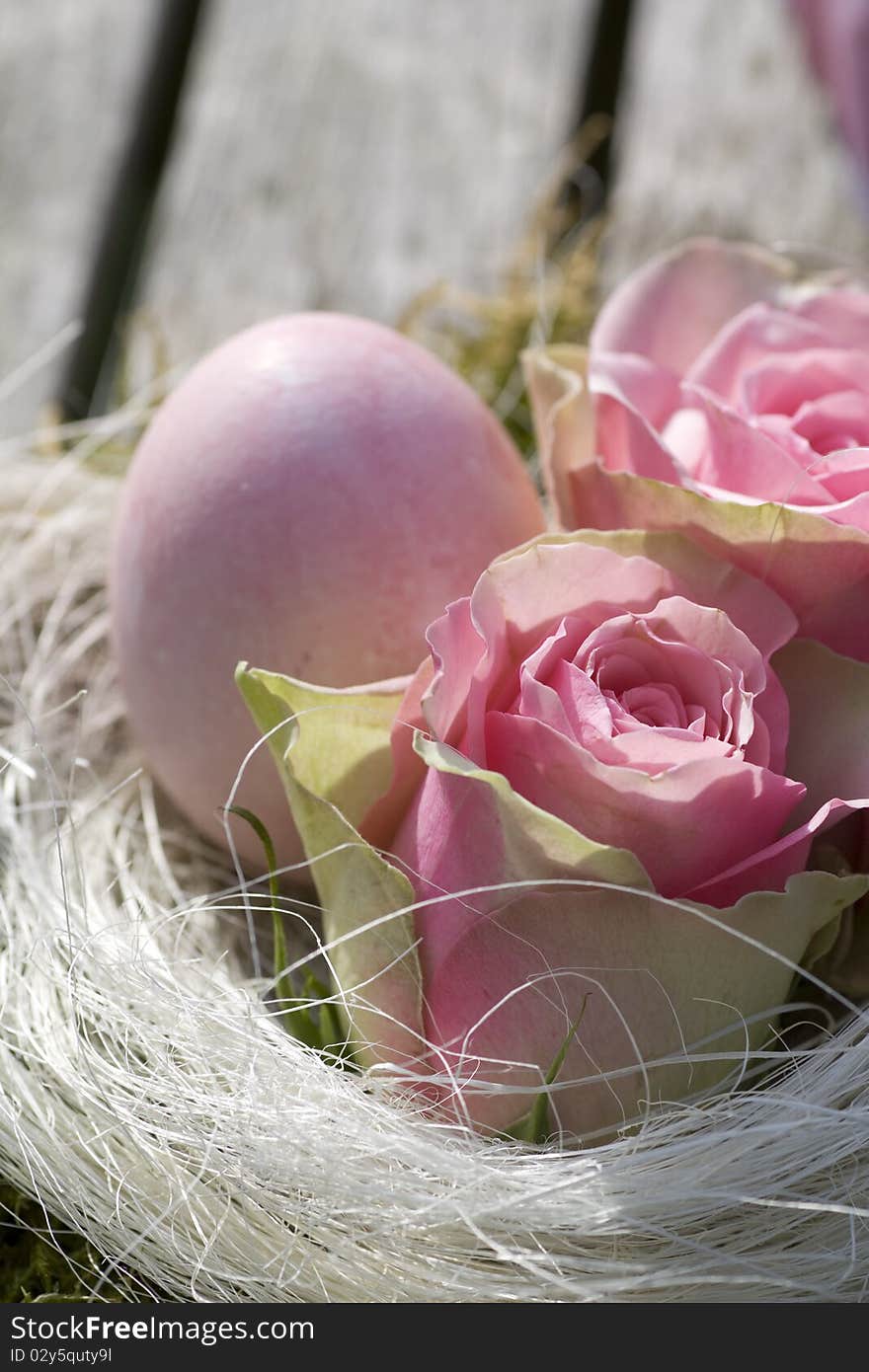 Easter egg in pink with roses in country style close-up