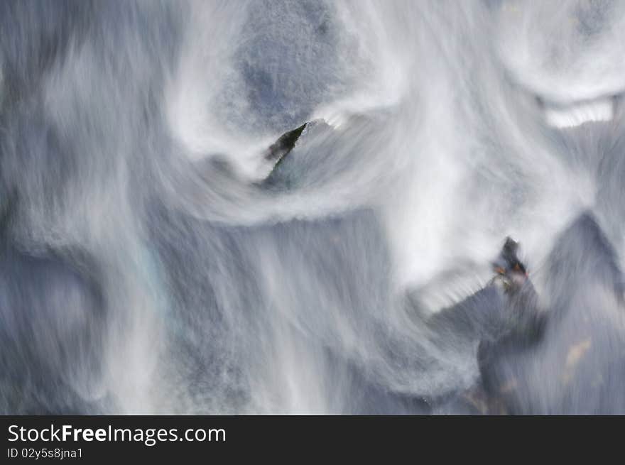 River running down over Stones, Wild Water with Foam and Sp