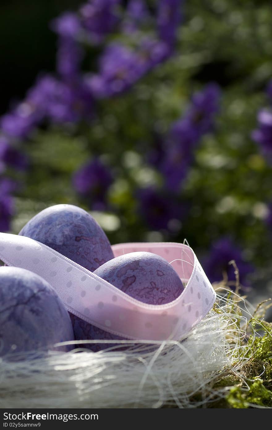 Easter eggs in purple with pink ribbon