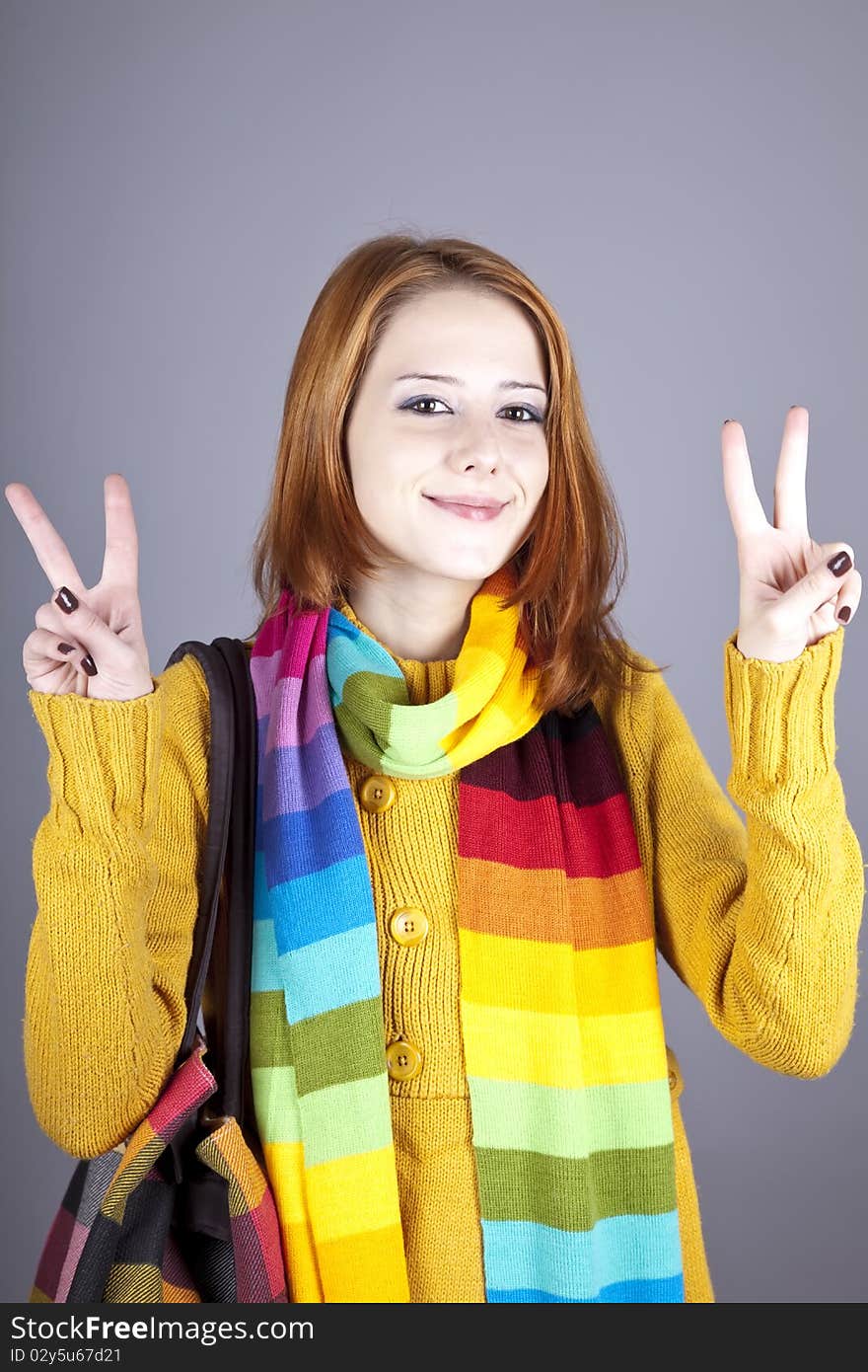 Portrait of red-haired girl in scarf. Studio shot.