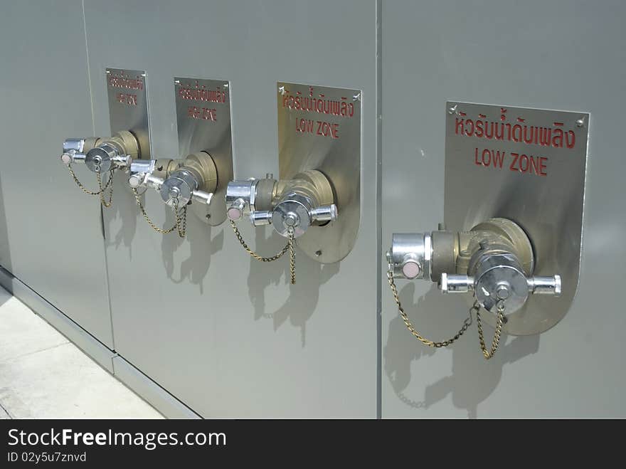 Four fire hydrants on the wall of Modern Building. Four fire hydrants on the wall of Modern Building.