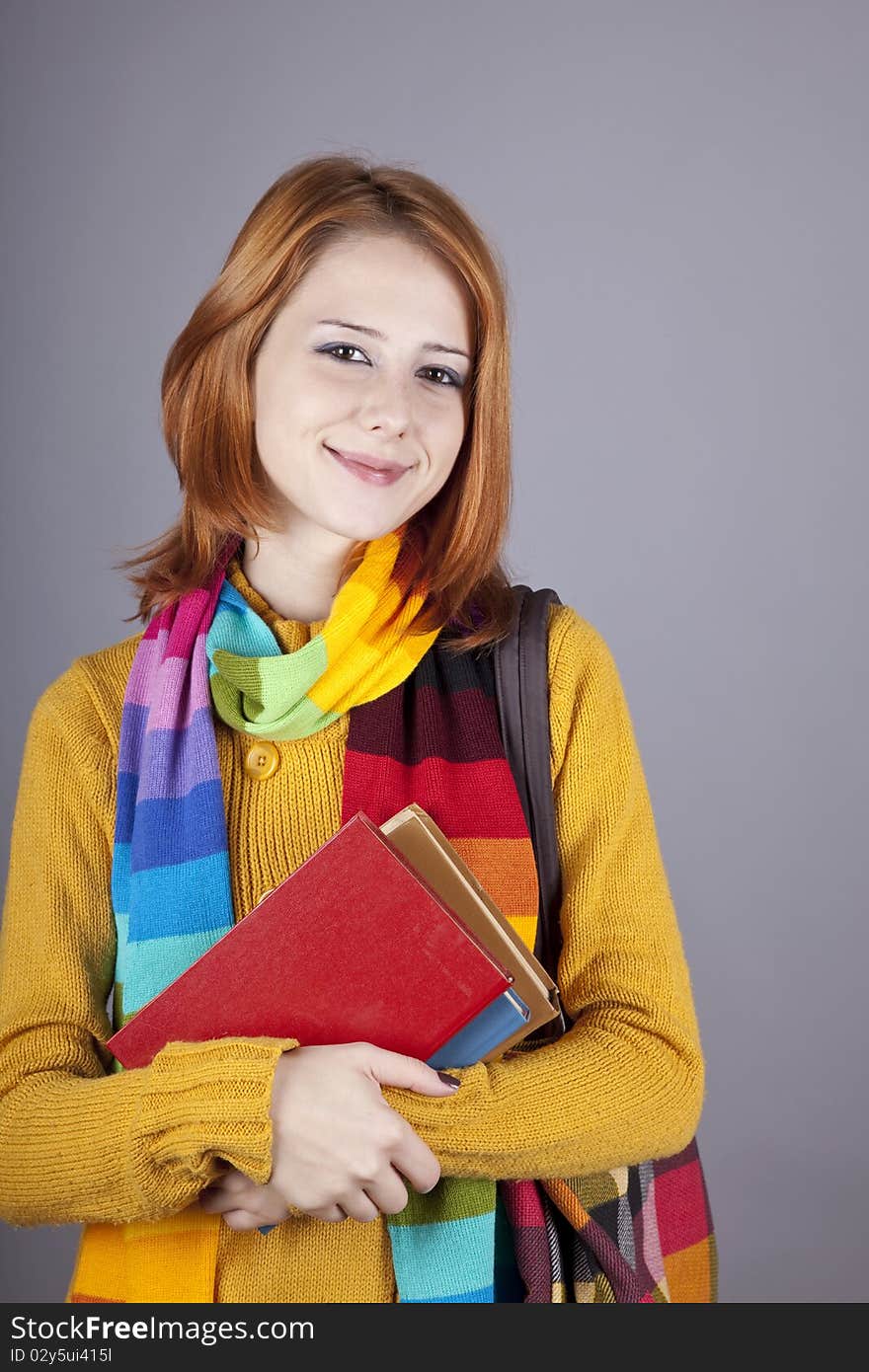 Young student girl with books. Studio shot.