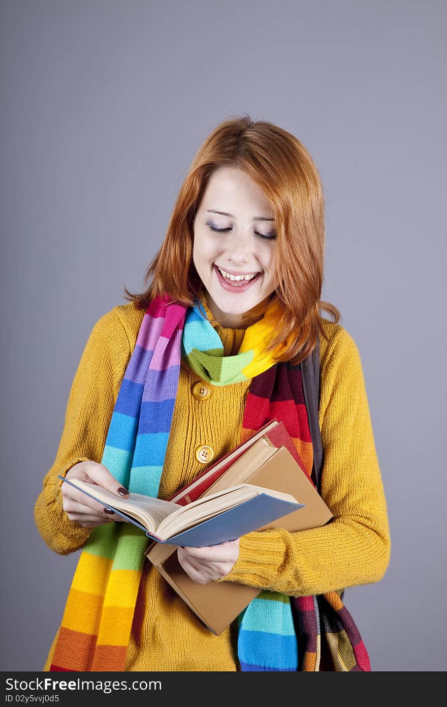 Young student girl with books.