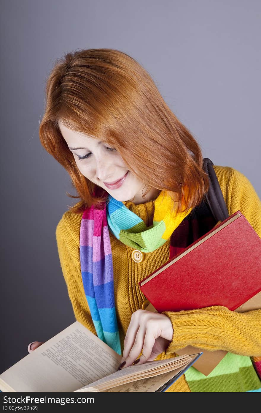 Young student girl with books. Studio shot.