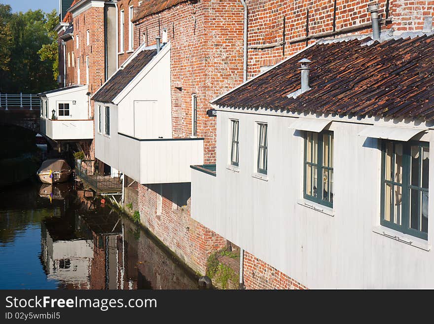 Historic old Dutch city with wooden house extensions above the canal. Historic old Dutch city with wooden house extensions above the canal