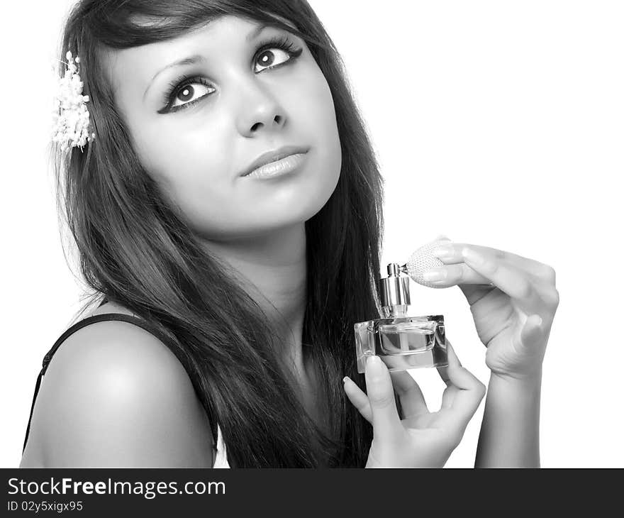 Young woman applying perfume on her neck.