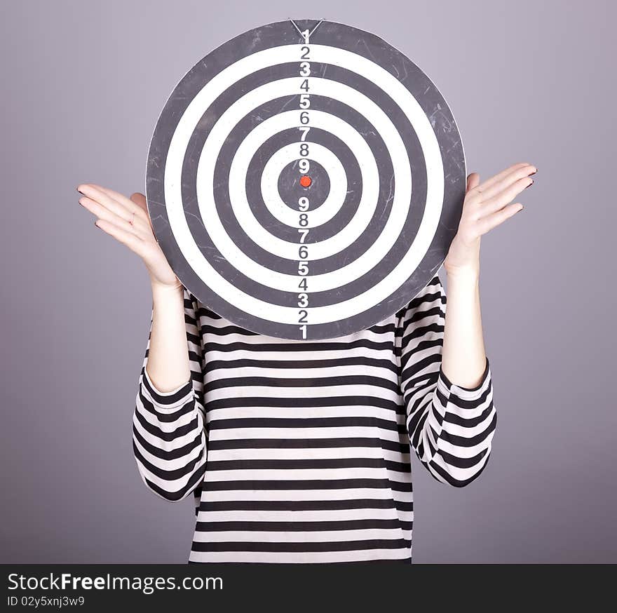 Red-haired girl with dartboard.