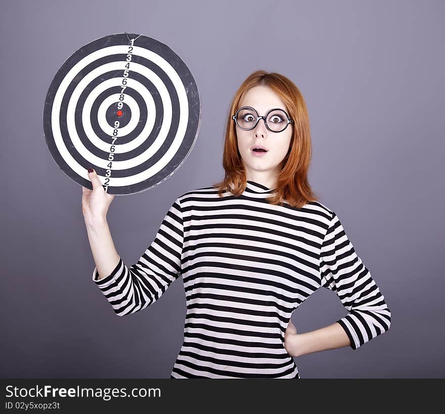 Red-haired girl with dartboard.