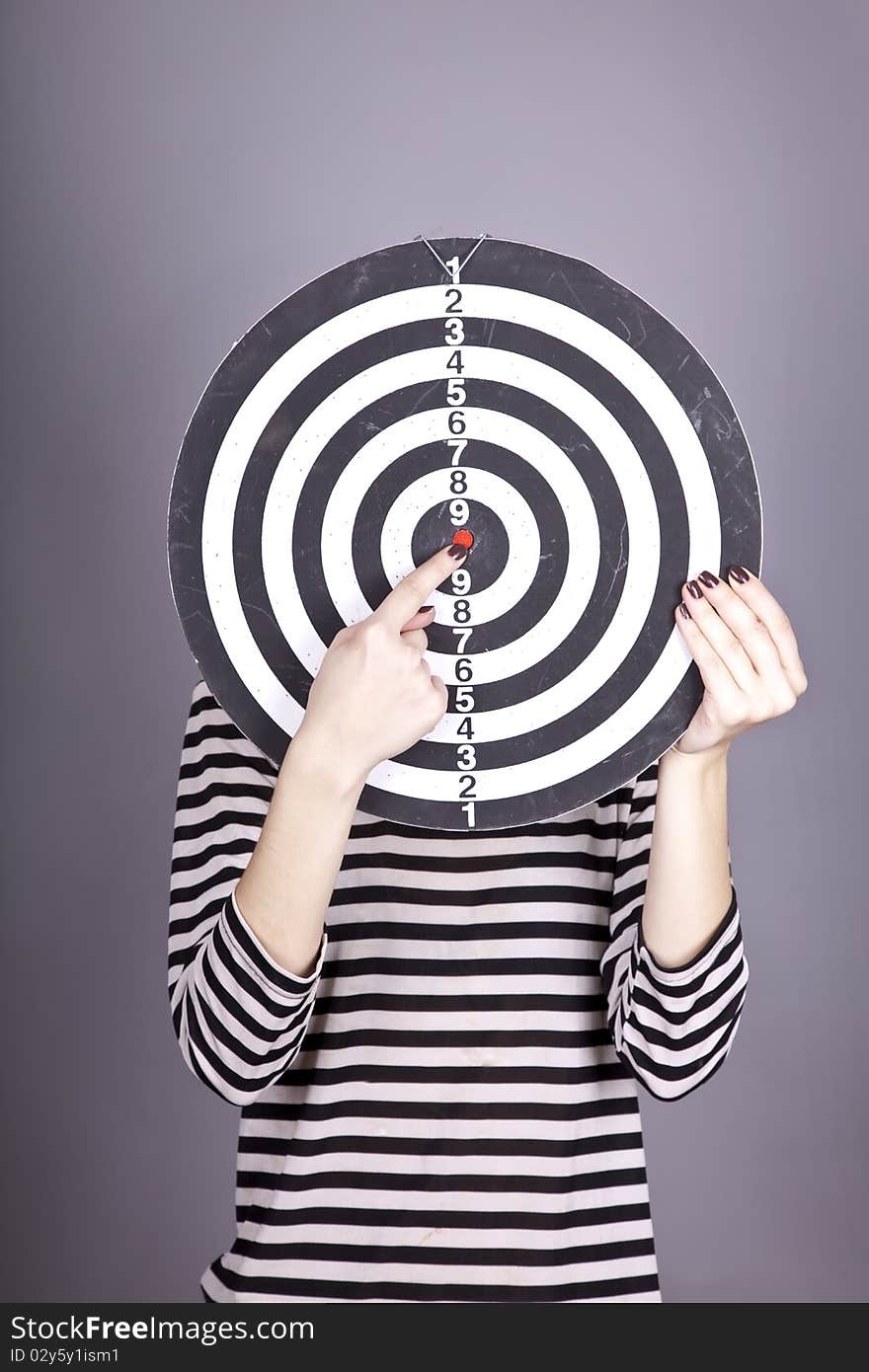 Girl with dartboard in place of head.