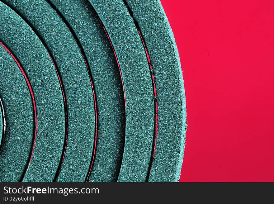 Macro shot of mosquito coil with pink background. Macro shot of mosquito coil with pink background.