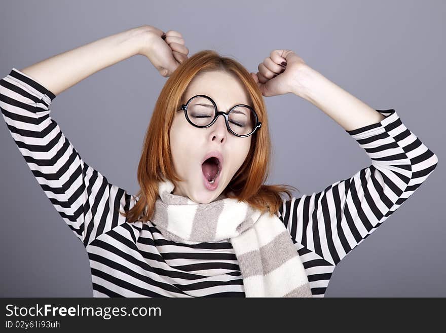 Sleeping red-haired girl in glasses and scarf.