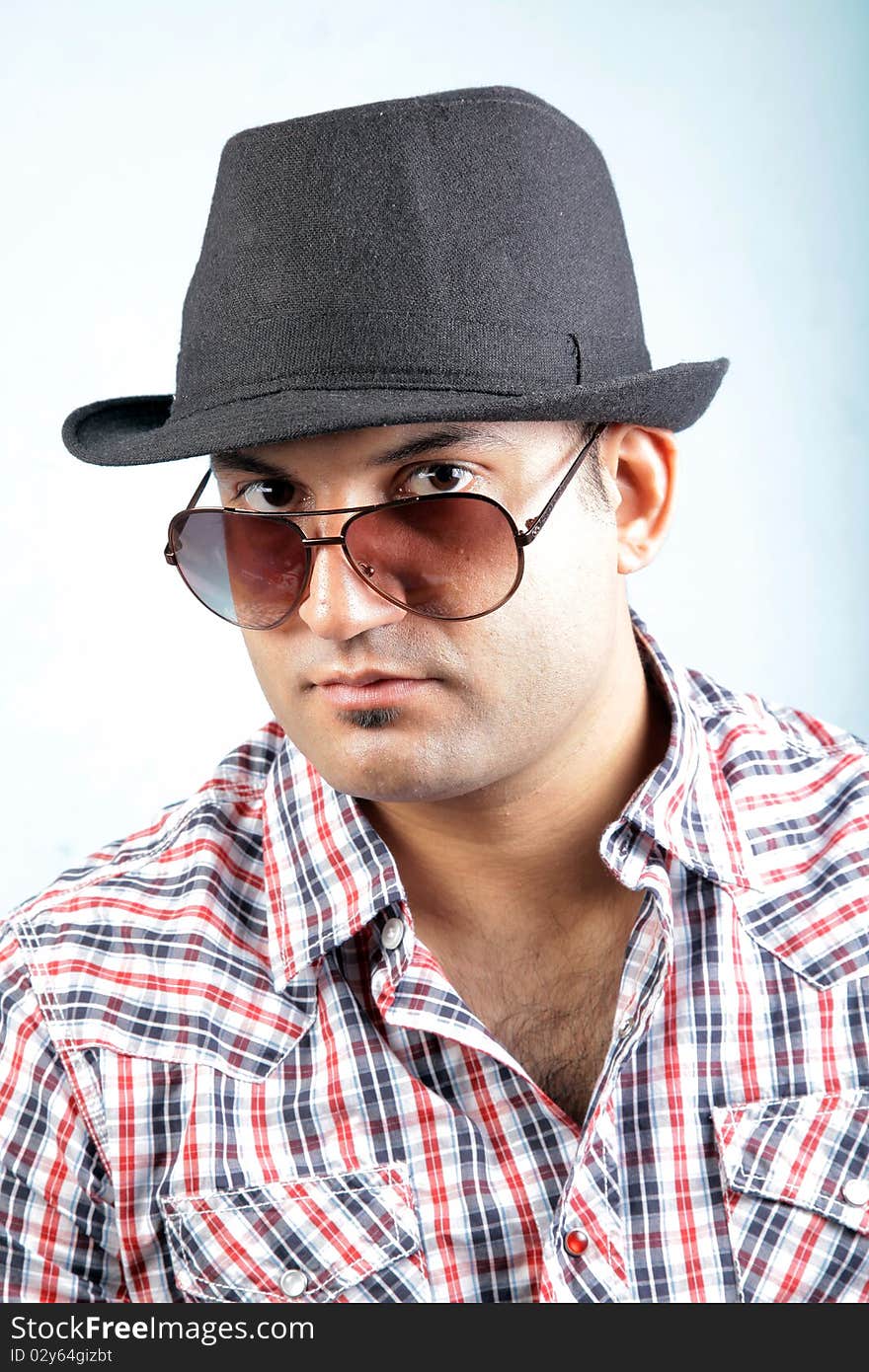 A young male fashion model wearing a black hat and goggles. A young male fashion model wearing a black hat and goggles.