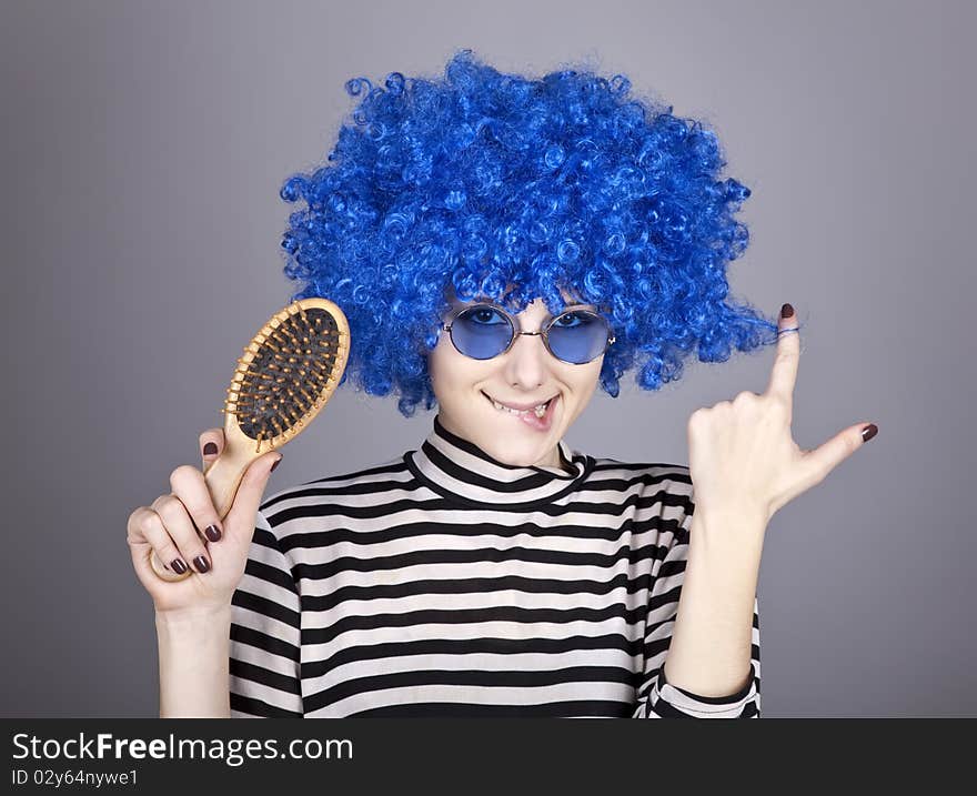 Coquette blue-hair girl with comb. Studio shot.