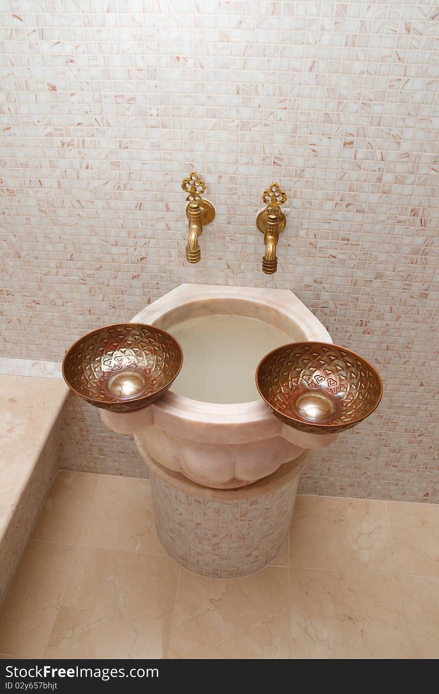 Faucets and two copper bowls in turkish bath. Faucets and two copper bowls in turkish bath