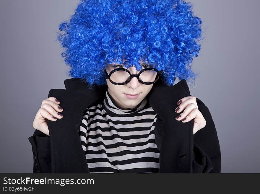 Funny blue-hair girl in glasses and black coat.