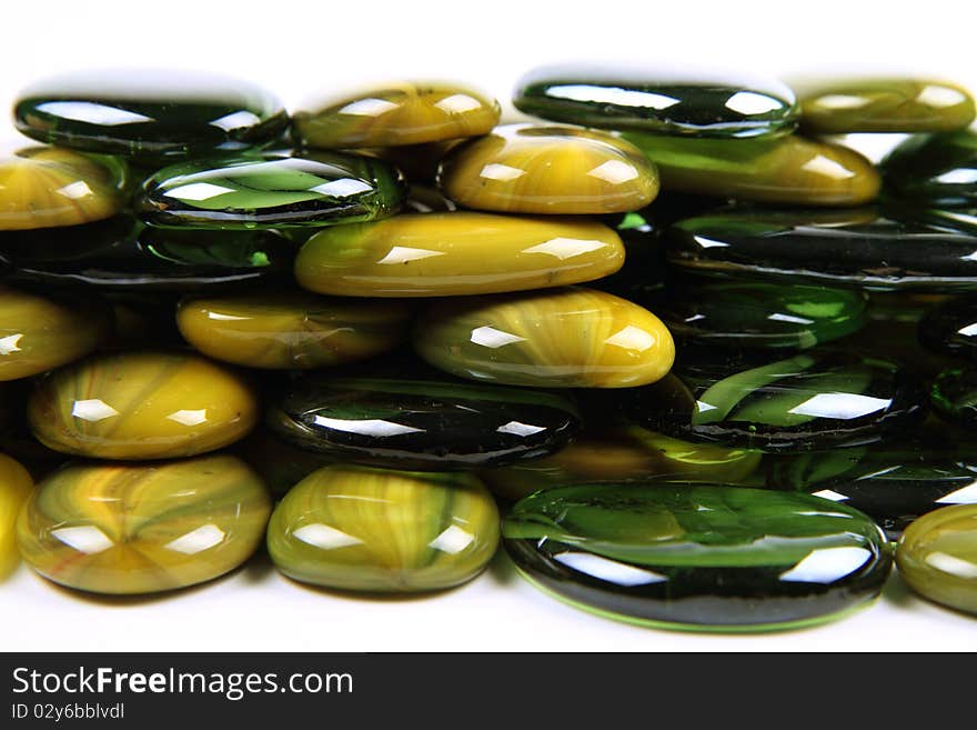 Green and yellow decorative stones on white background. Green and yellow decorative stones on white background