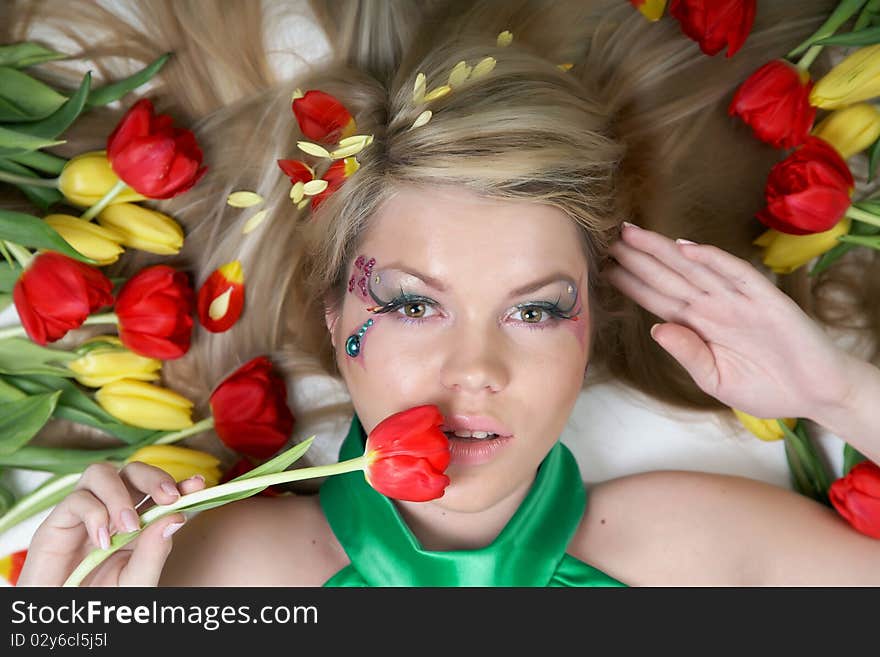 Happy young woman with tulips around. Happy young woman with tulips around