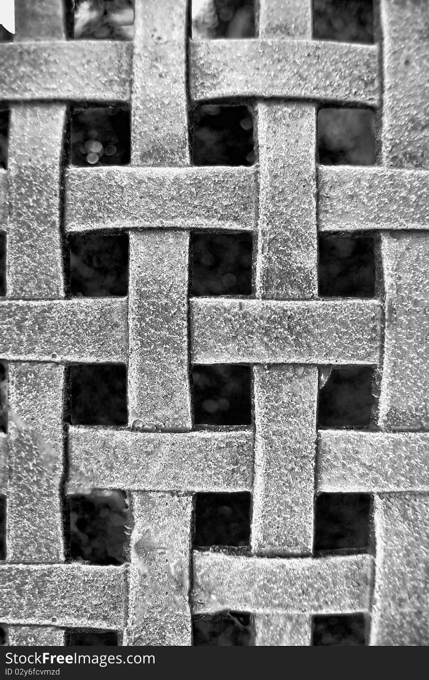 Woven Metal Mesh Grid Pattern on a black background