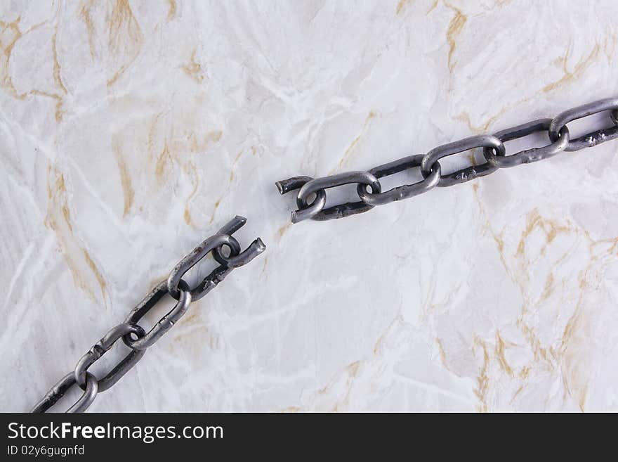 Broken chain over marble texture background