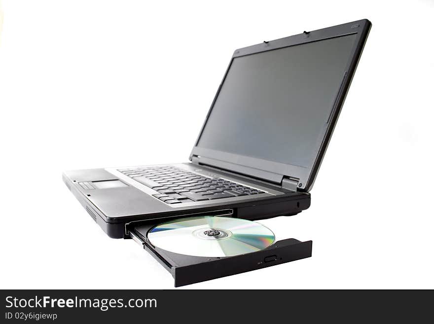 Laptop with open drawer and disc.