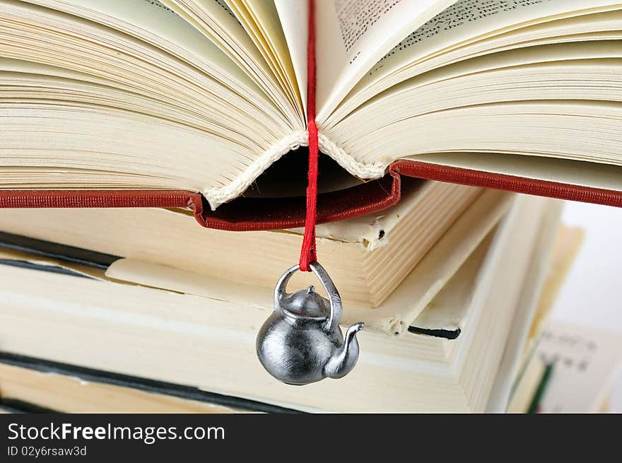 Stack of used books with a hand-made bookmark