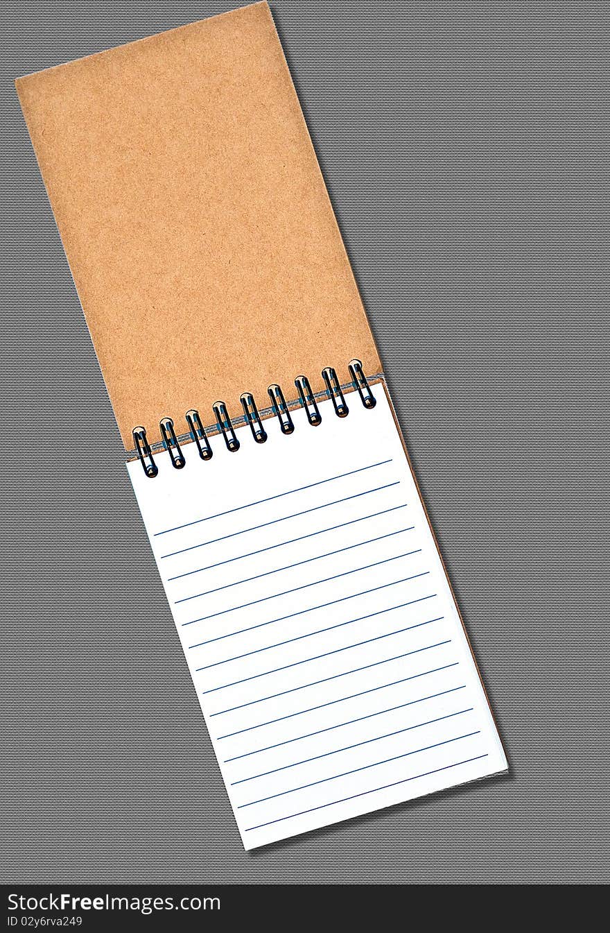 Notebook on textured background, blank for your text. Notebook on textured background, blank for your text.