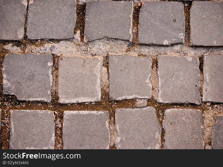 Grey square tiles of pavement forming a pattern. Grey square tiles of pavement forming a pattern