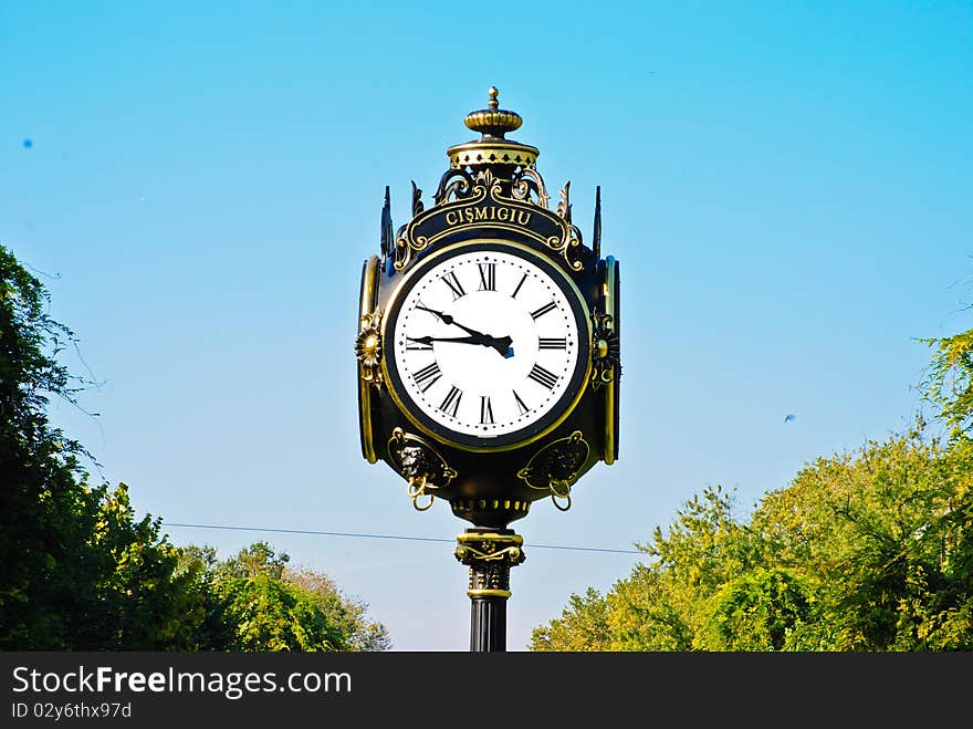 Vintage black and white clock and green trees. Vintage black and white clock and green trees