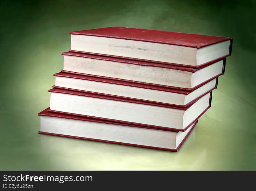 Set of redish orange old books on studio background with copy space