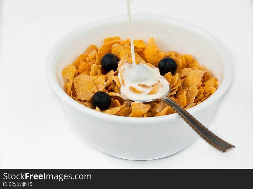 Pouring milk into bowl of cereal