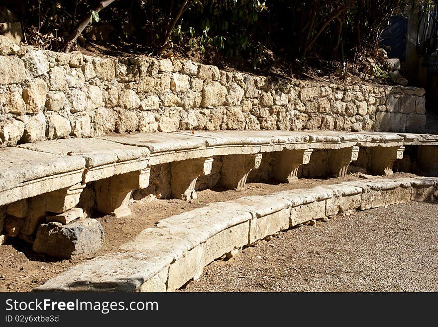 Ancient stone benches in a courtyard
