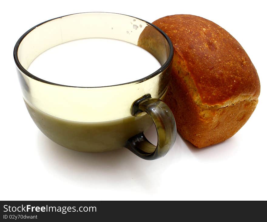 Black bread with milk in a mug on the white isolated background